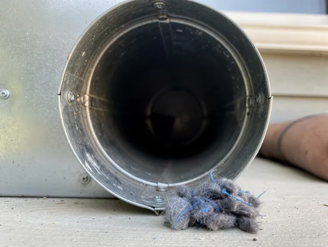 Rock Hill Dryer Vent Cleaning technician using specialized equipment to clear severe dryer vent blockage in Rock Hill